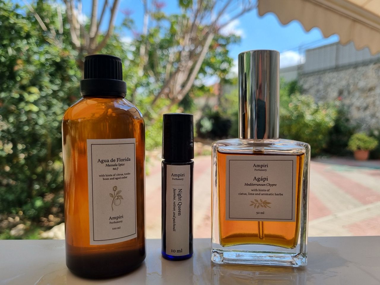 A 10 ml extrait between a bottle of Agua de Florida and a bottle of eau de parfum.