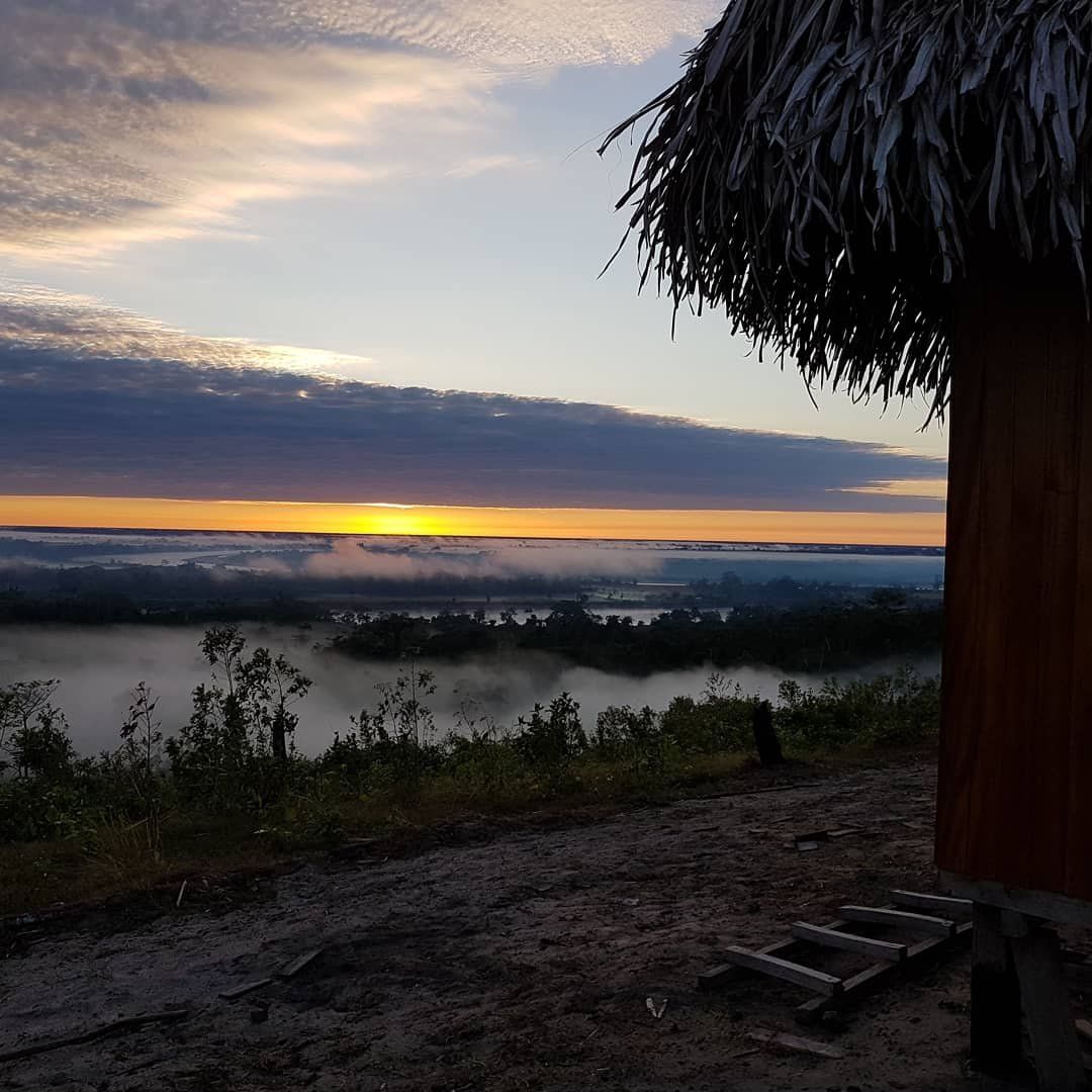 Hut at sunset over river, at Ampiri.