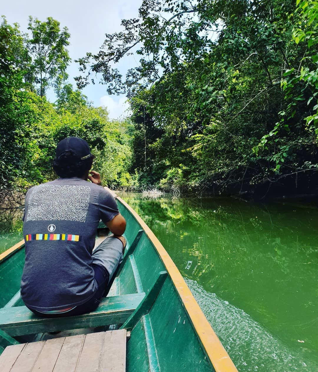 Person in canoe seen from behind, at Ampiri.