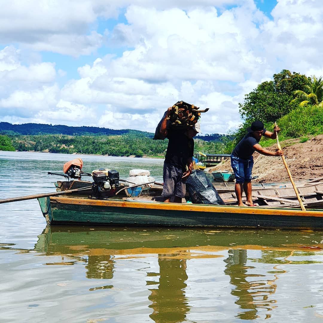 Boat on river with people small, at Ampiri.