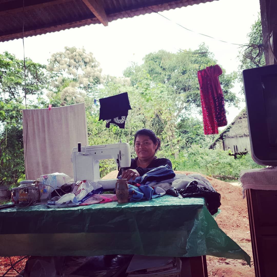 Man at outdoor table with equipment, small, at Ampiri.