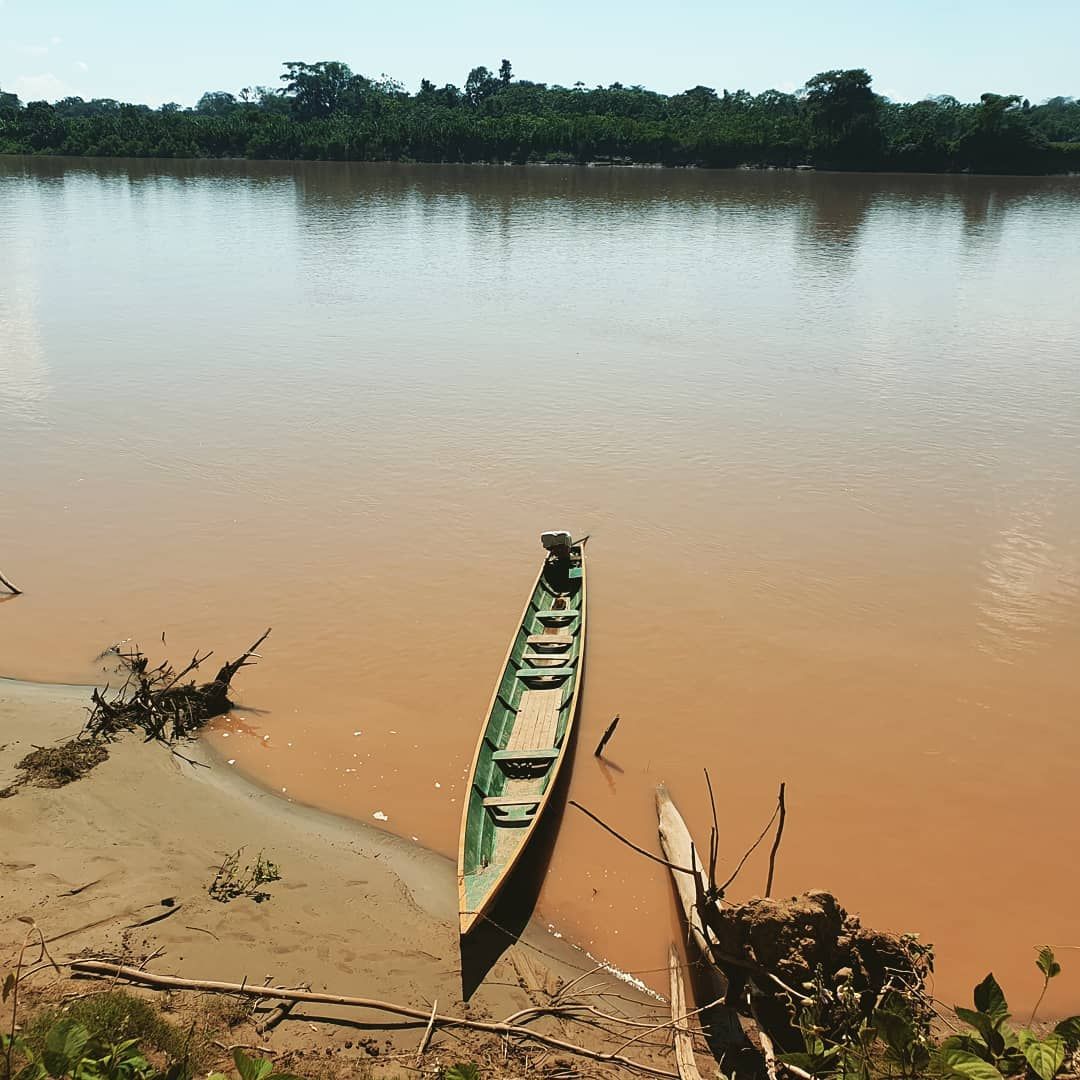 Brown river with boat, at Ampiri.