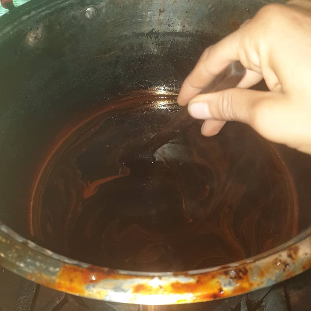 Hand in bowl of liquid, at Ampiri.