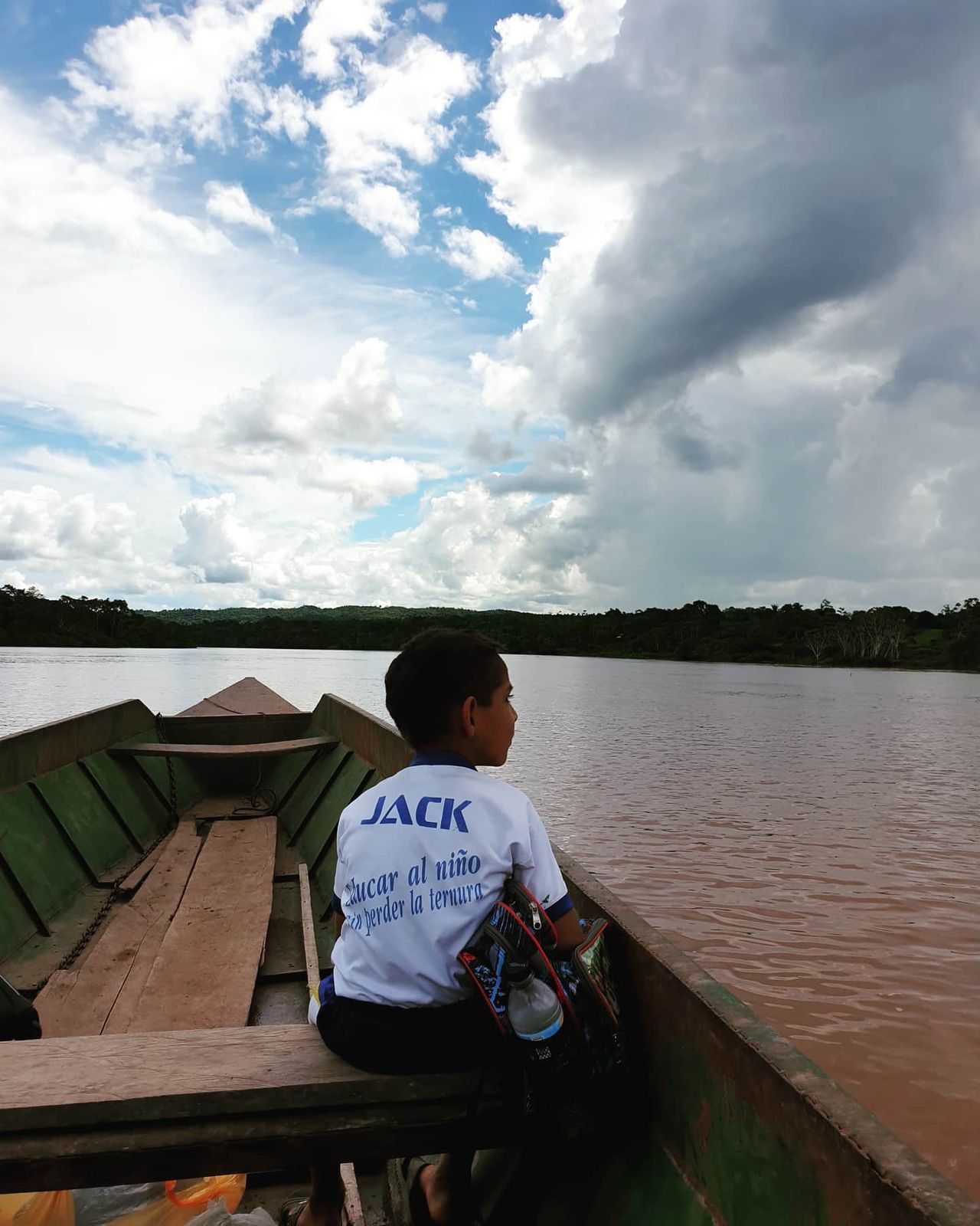 Person in canoe seen from behind, at Ampiri.