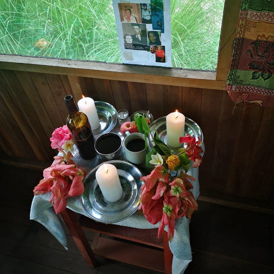 Table with flowers and bottles, at Ampiri.