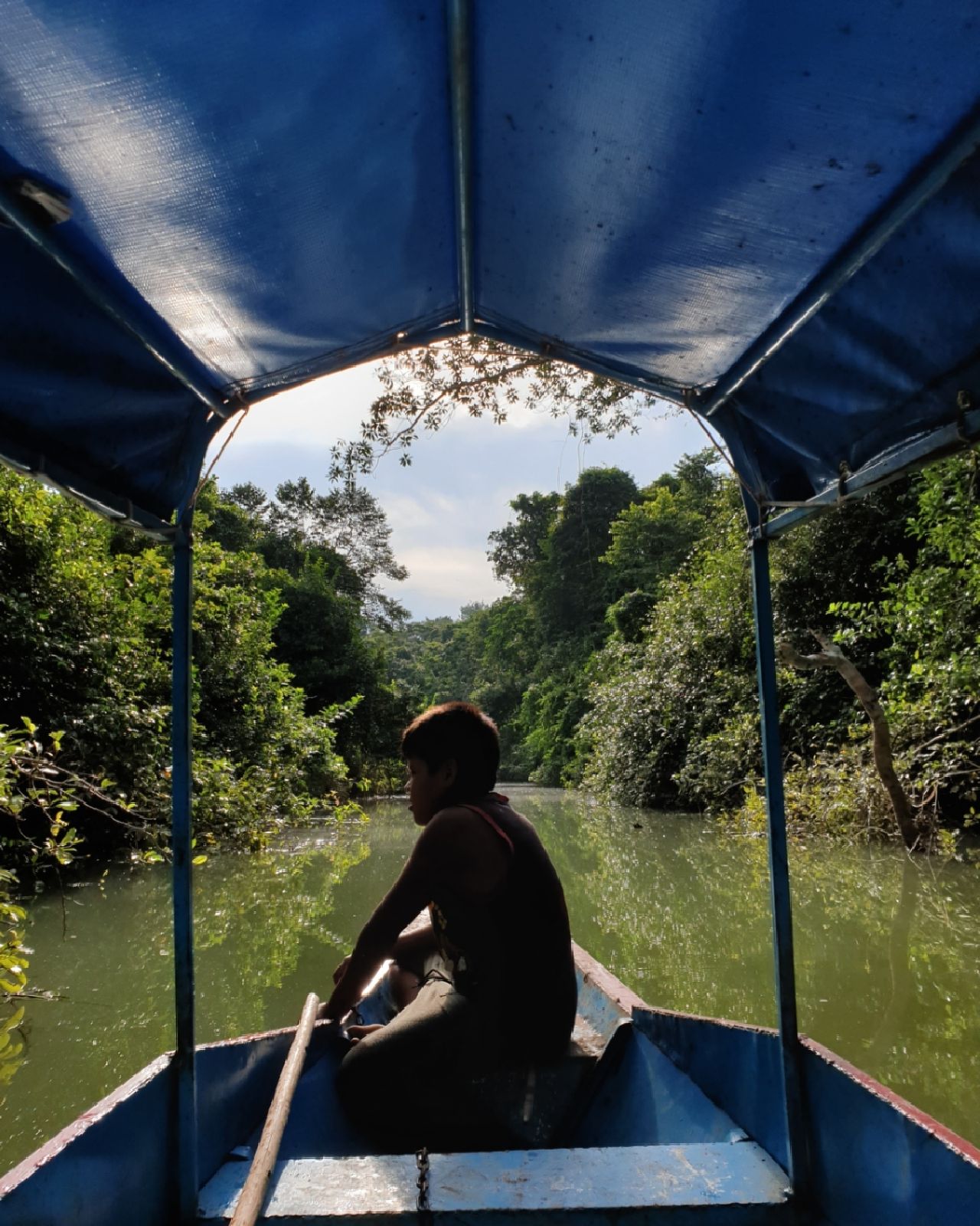Person from behind in boat, at Ampiri.