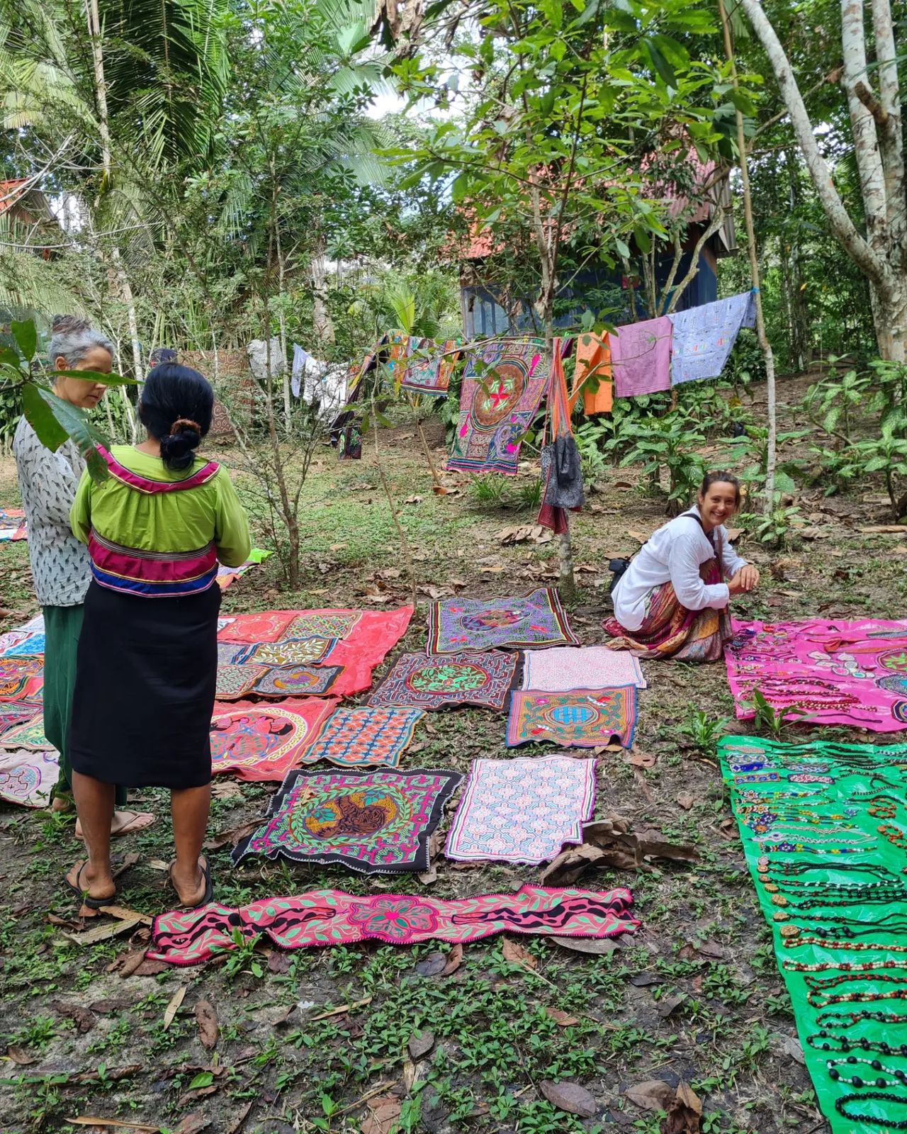 Woman on mat, small in frame, at Ampiri.