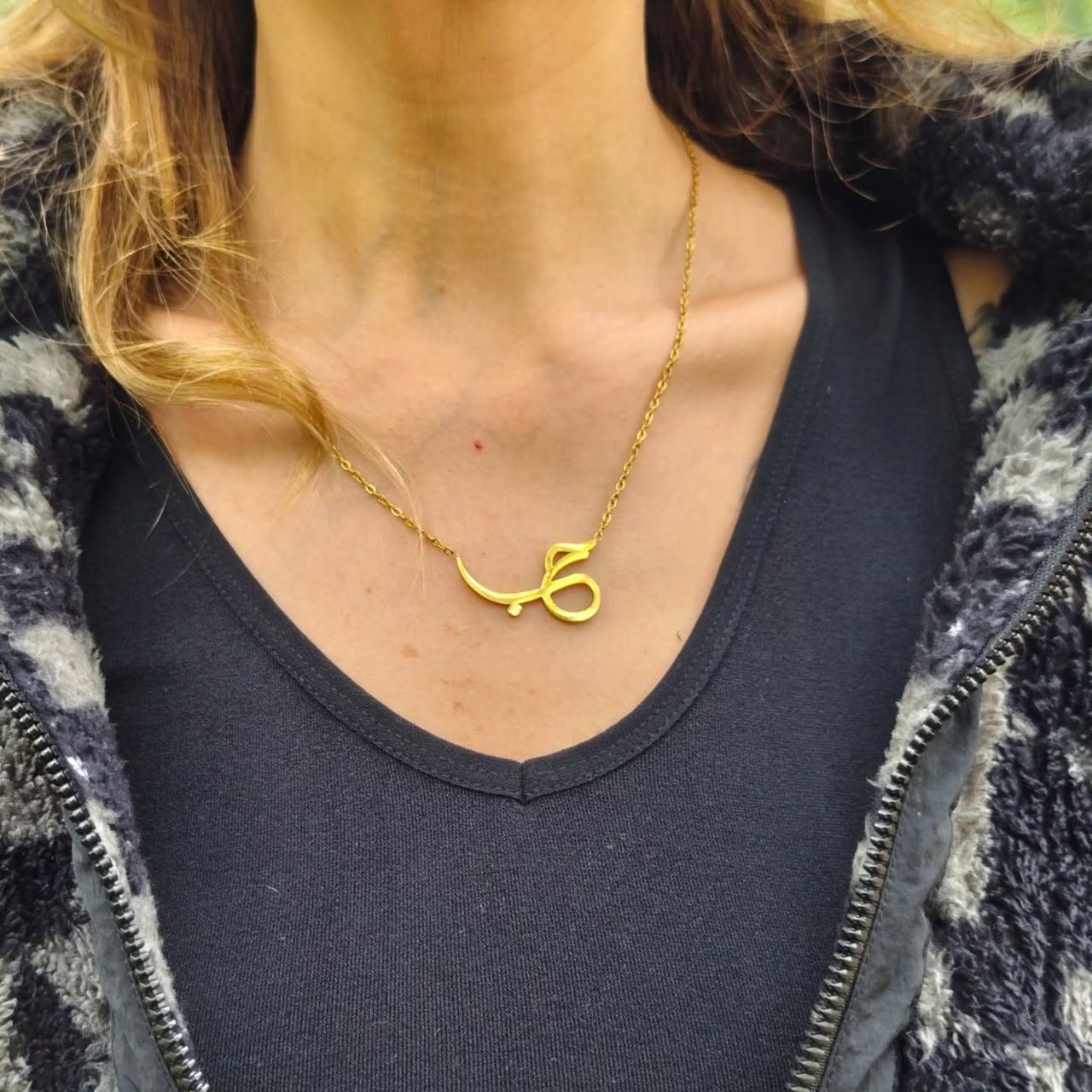 Necklace on woman's neck, no face, at Ampiri.